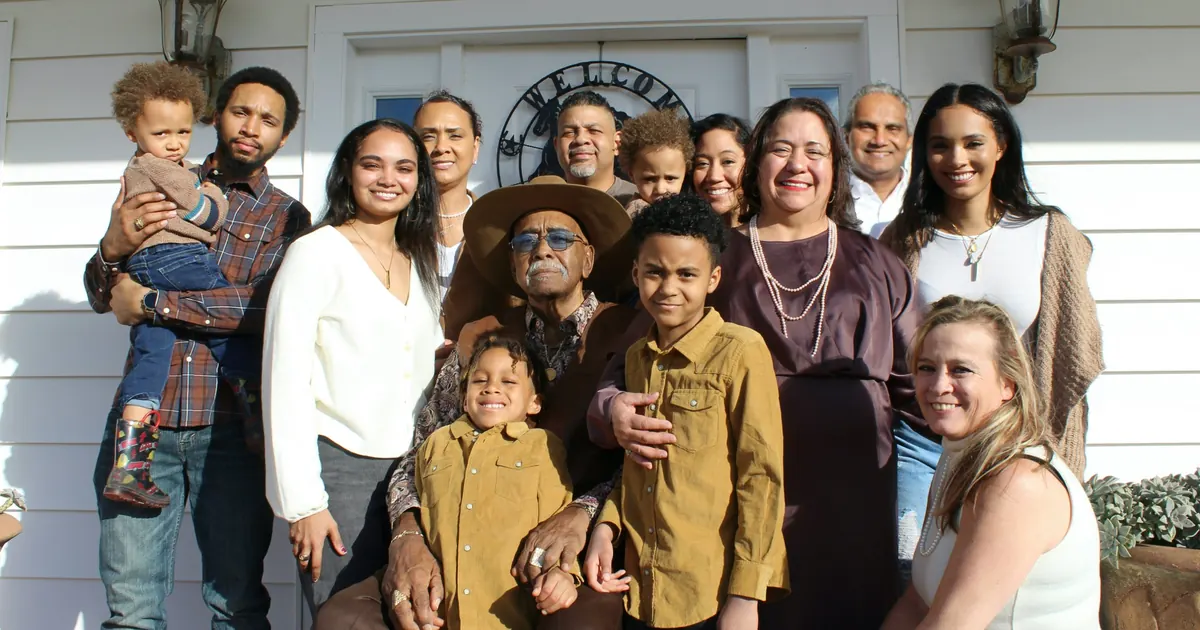 A big multigenerational family gathered together on a front porch
